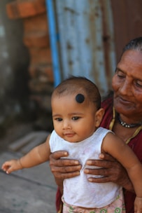 a woman holding a baby in her arms