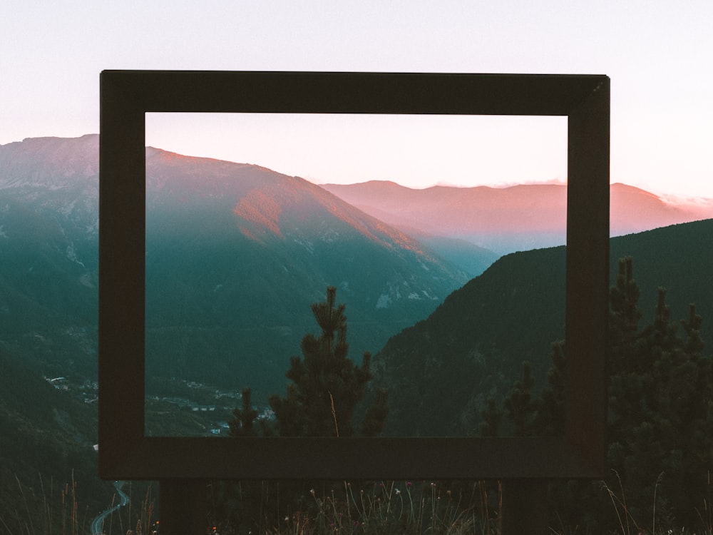a picture frame sitting on top of a hill