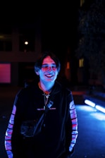 Smiling customer service representative wearing a headset and working late at night.