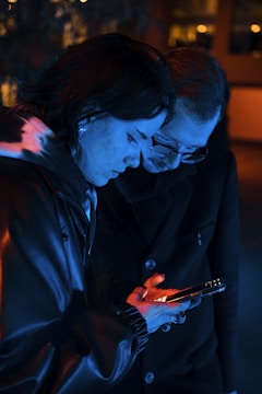 A tense moment between two characters in a suspenseful vertical drama, framed tightly on a smartphone screen.