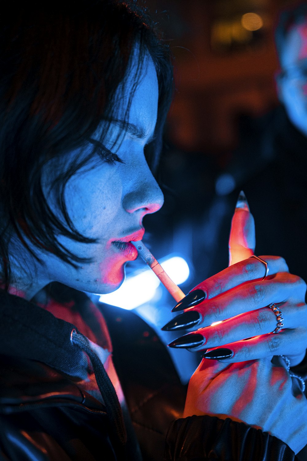 a woman smoking a cigarette in the dark