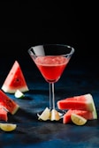 a watermelon martini garnished with a slice of watermelon