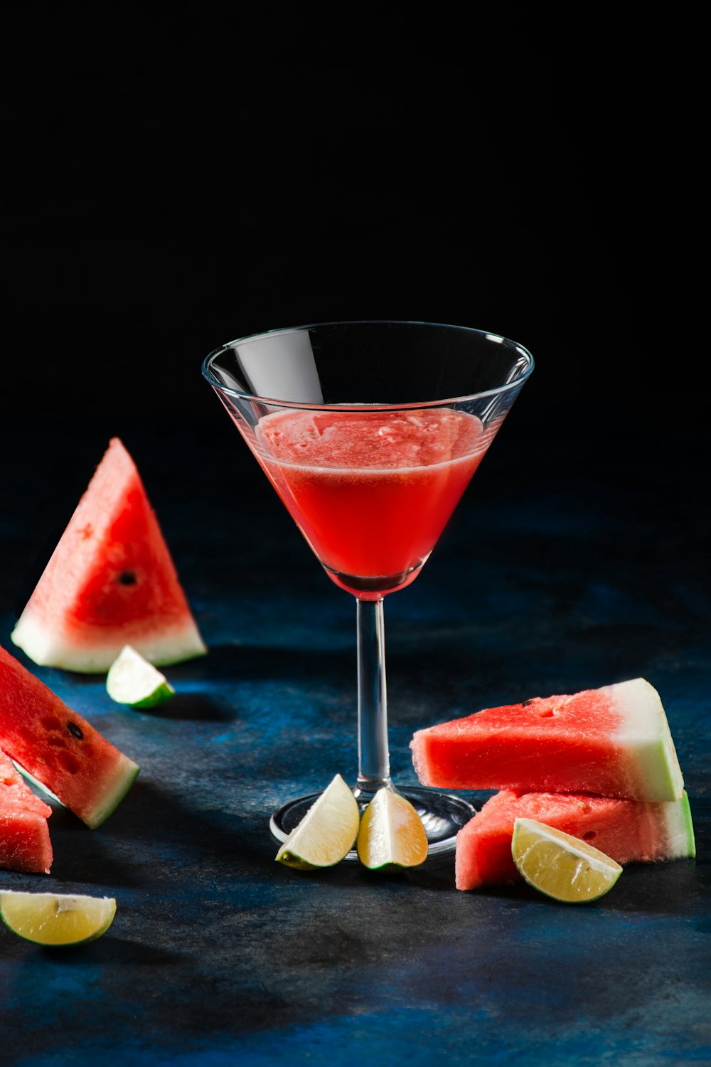 a watermelon martini garnished with a slice of watermelon