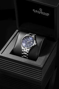 a watch sitting on top of a black box