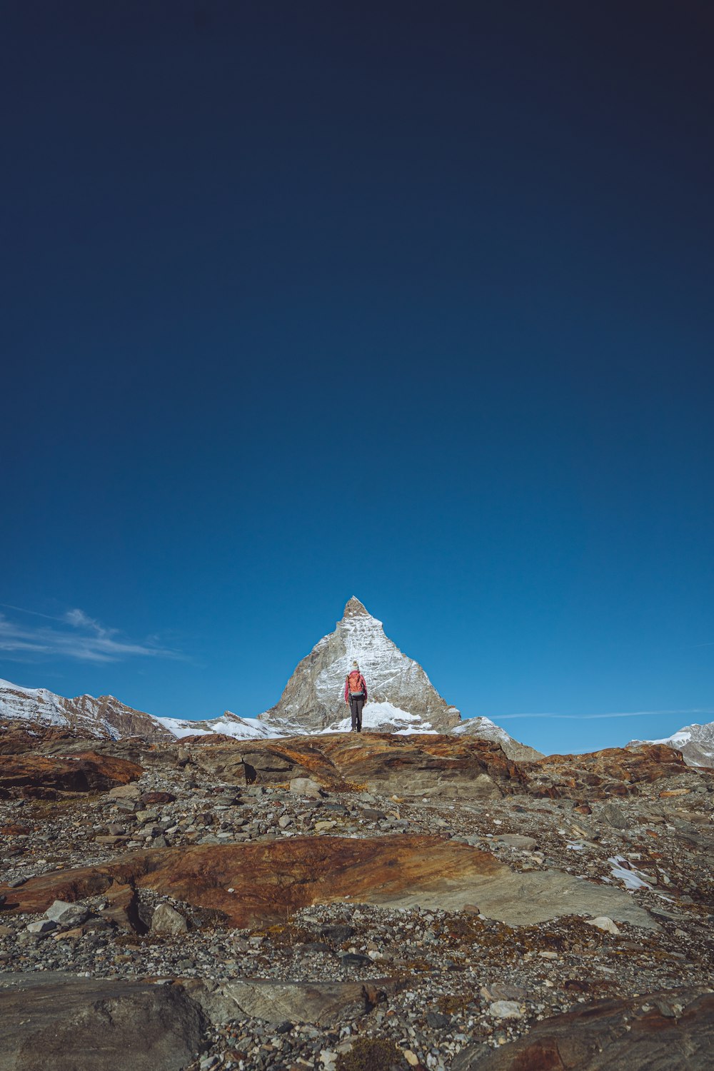 a person standing on top of a rocky hill