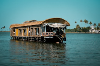 a house boat floating on top of a body of water