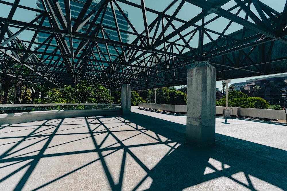 an empty parking lot with a metal structure in the middle