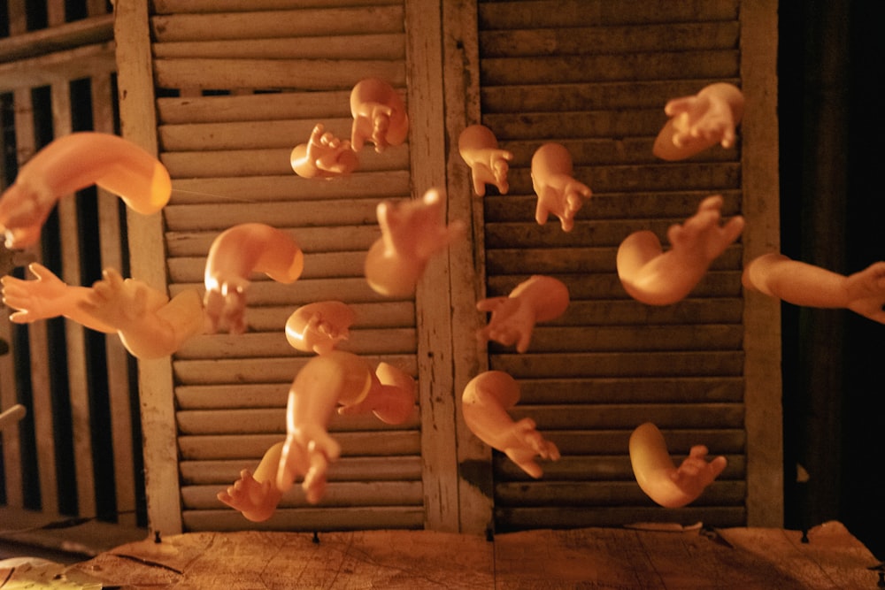 a wooden table topped with lots of fake animals