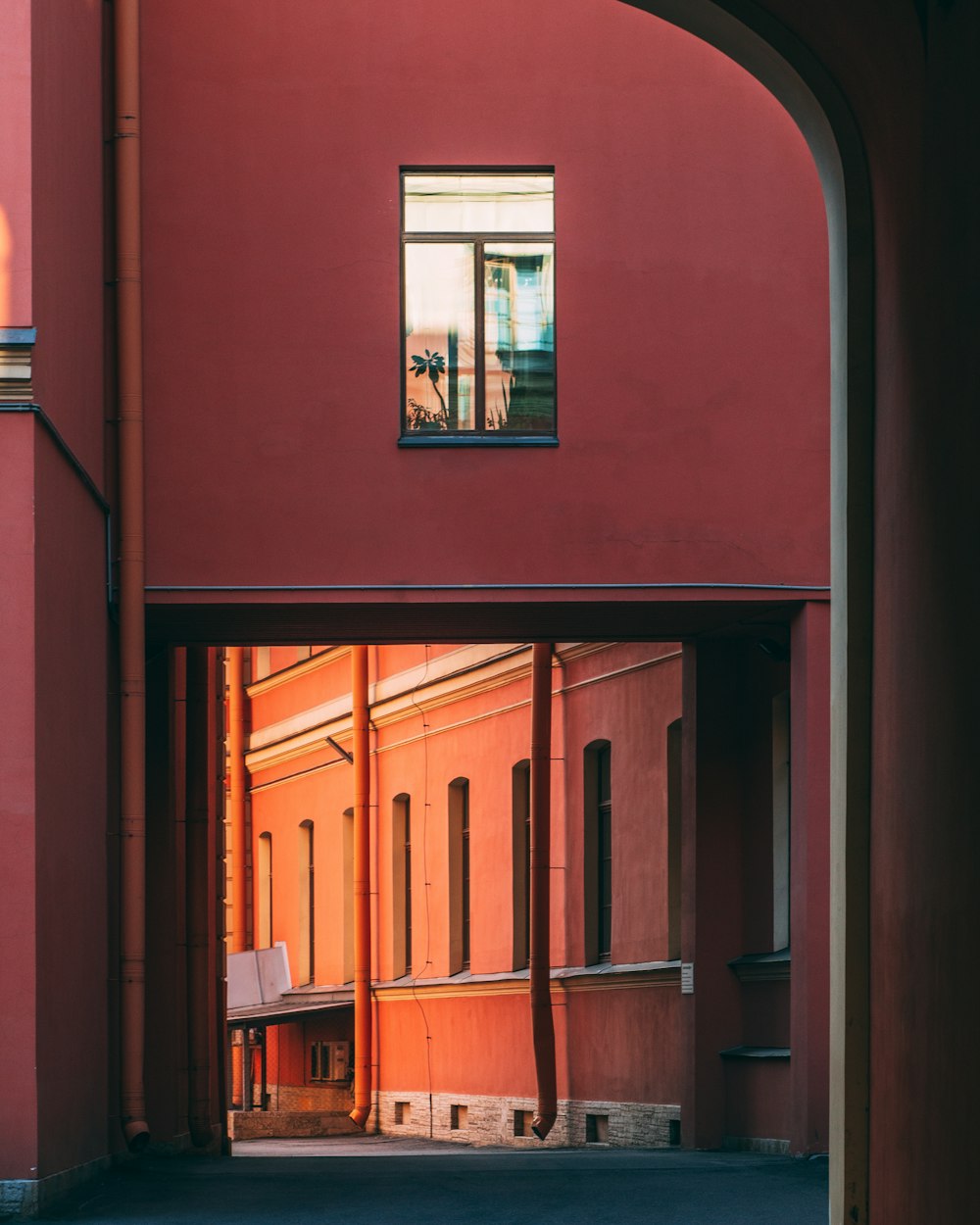 a red building with a small window in the middle of it