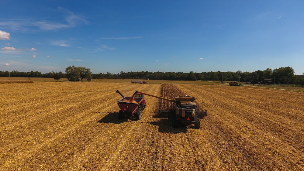 a large field with a couple of farm equipment in it