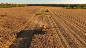 a tractor is driving through a large field