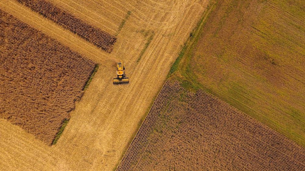 an aerial view of a tractor in a field