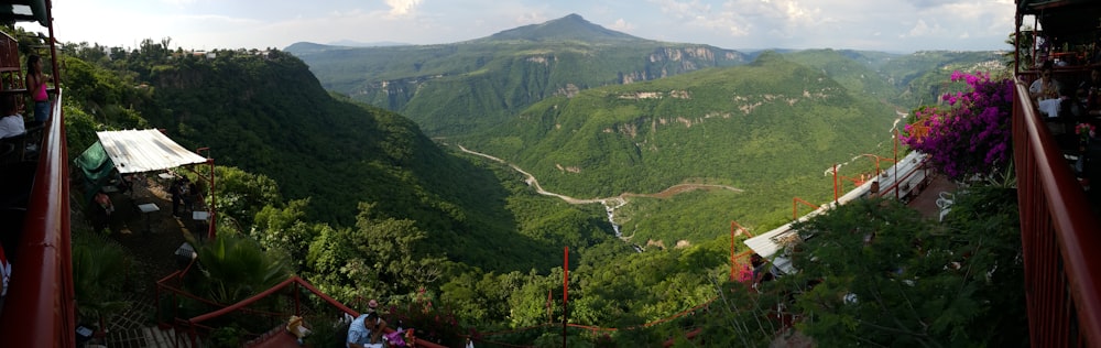 a scenic view of a valley with mountains in the background