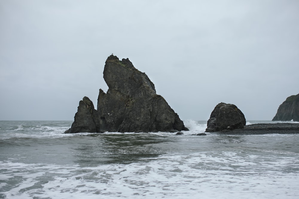 a large rock sticking out of the ocean