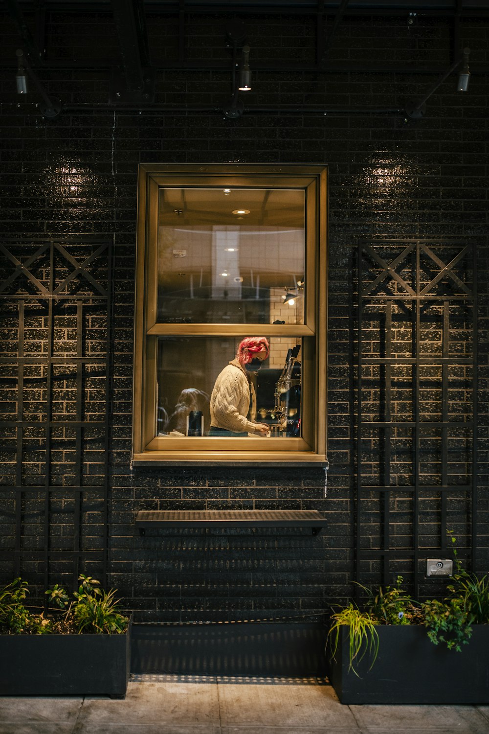 a person sitting in a window of a building