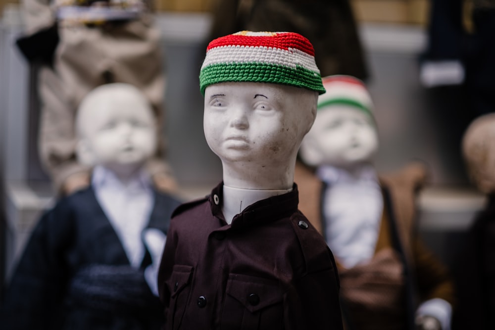 a group of mannequin heads with hats on them