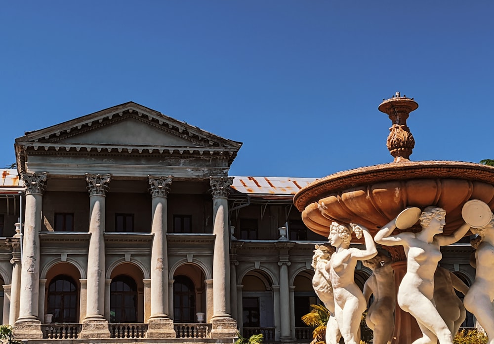 a fountain in front of a large building