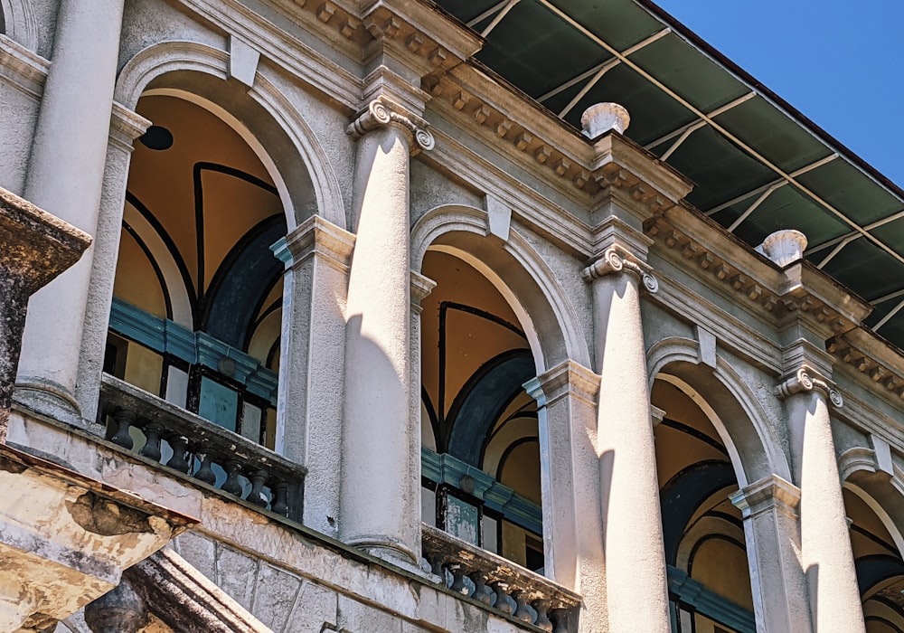 a building with columns and a clock on the front of it