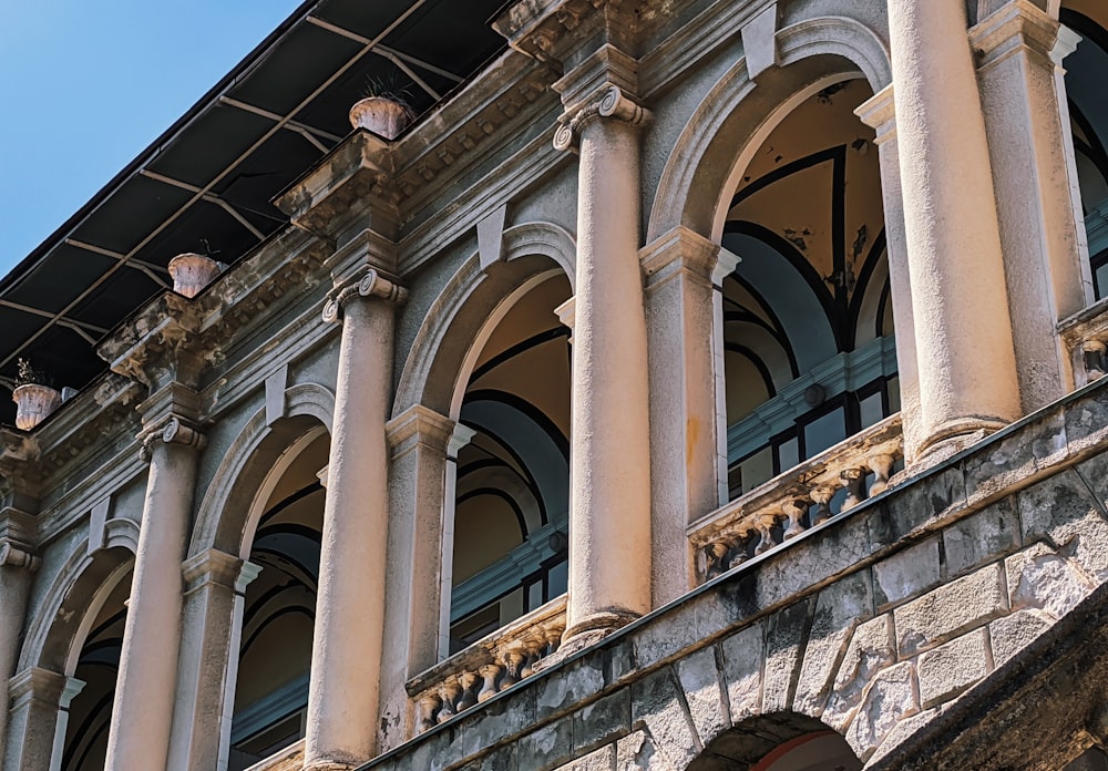 a building with columns and a clock on the front of it