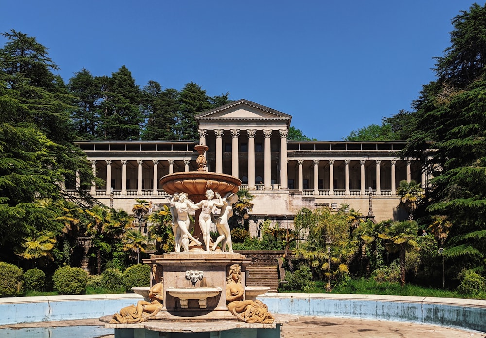 a fountain in front of a building with columns