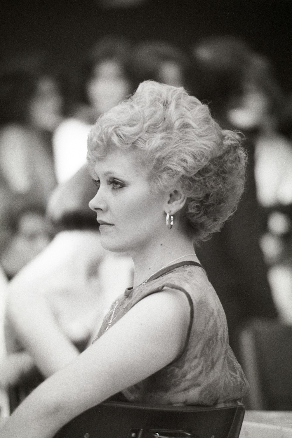 a black and white photo of a woman with a purse