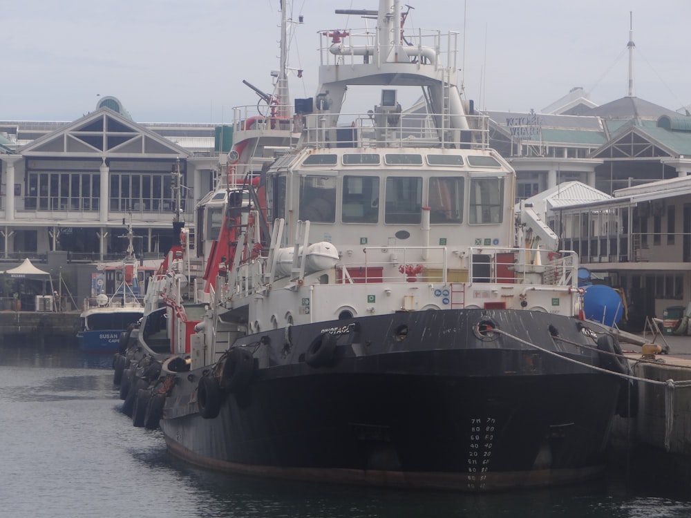 a large boat docked in a harbor next to a building