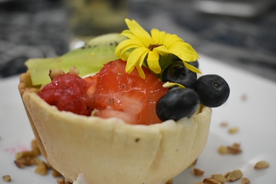 A colorful fruit tart with a golden crust and vibrant seasonal fruits.