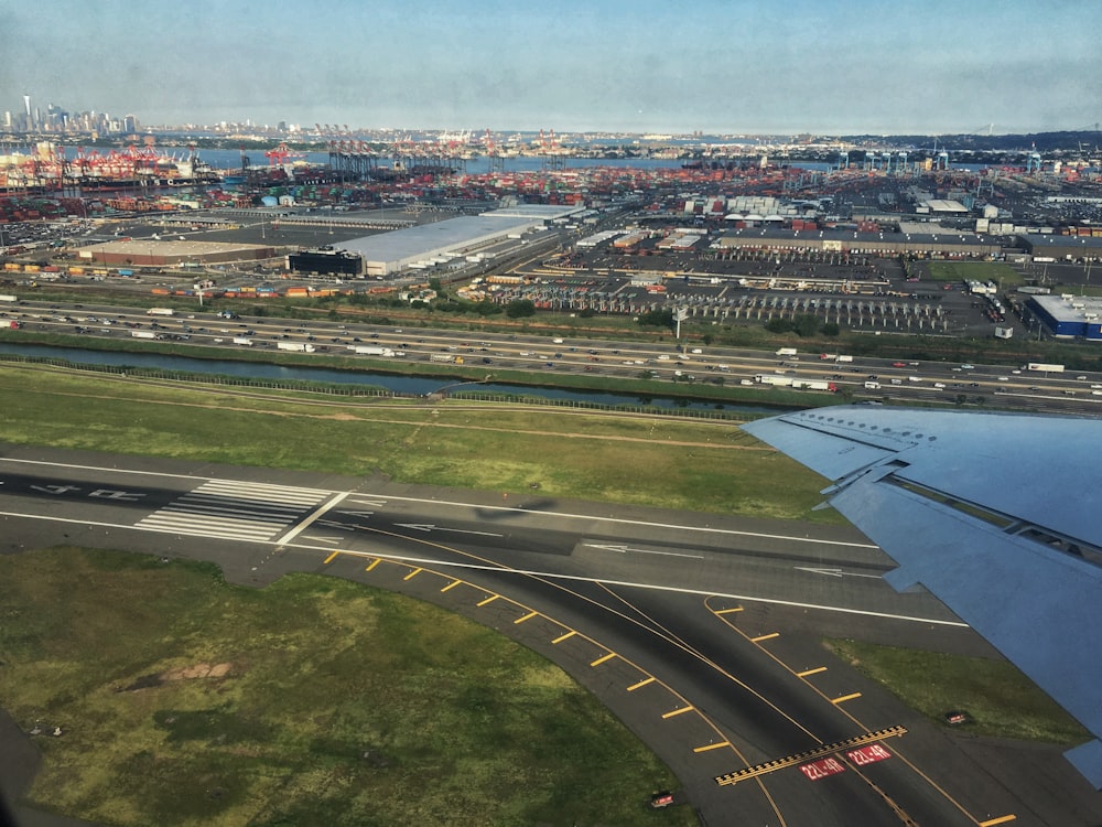 an aerial view of an airport with a body of water in the background