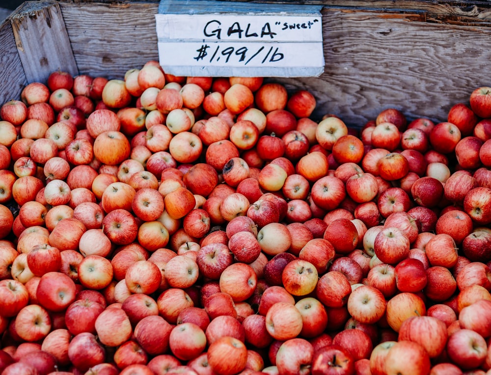 a crate filled with lots of red apples