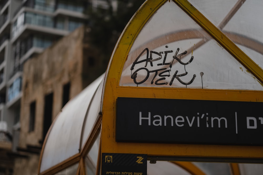 a bus stop with graffiti on the side of it