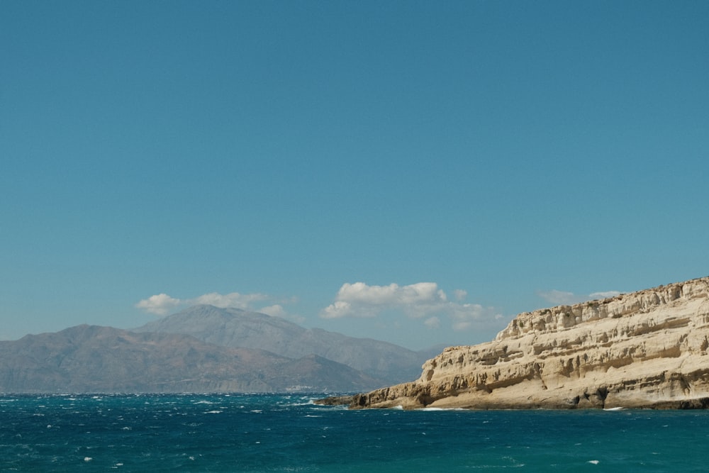 a large body of water with a mountain in the background