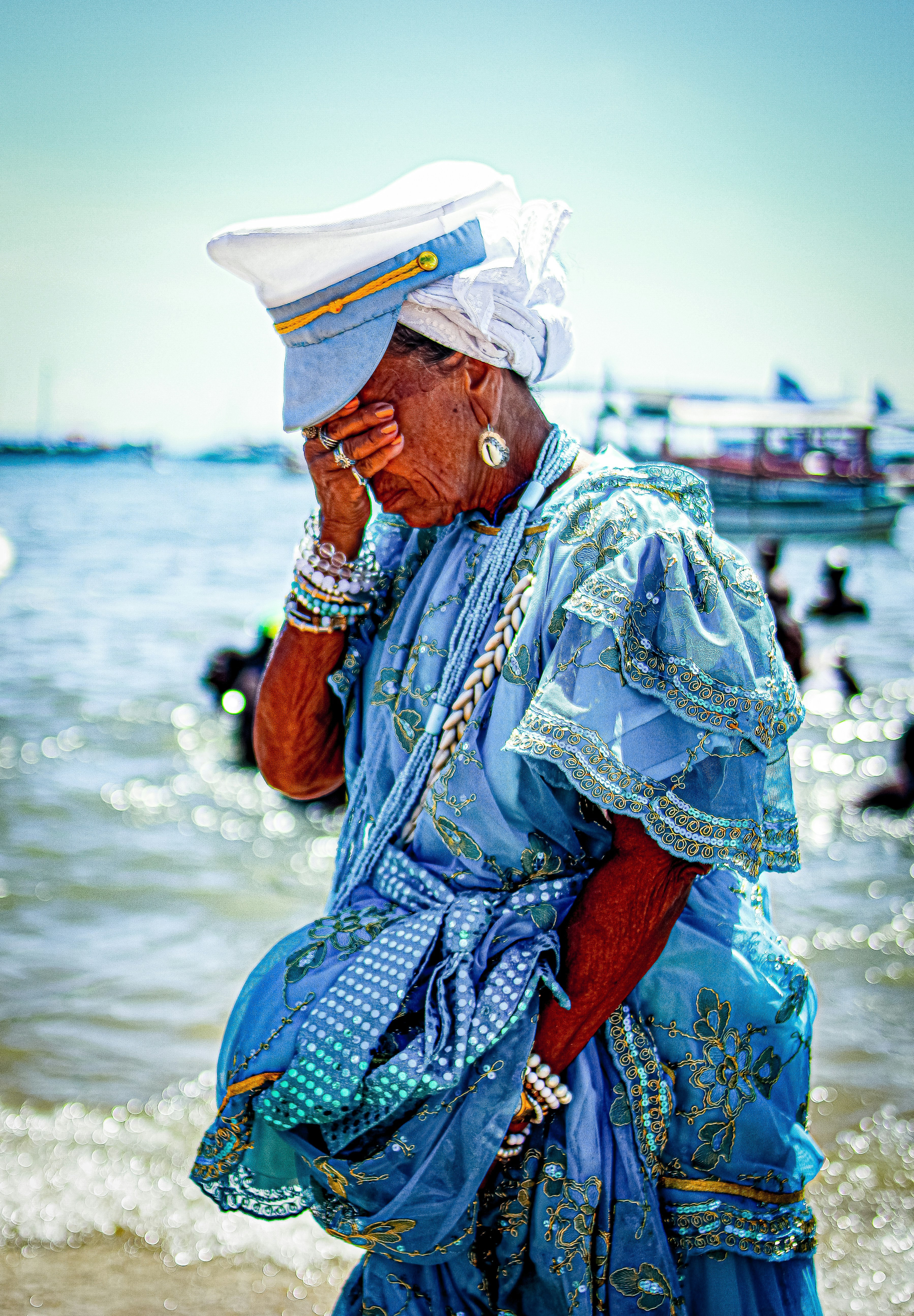 A woman in a blue dress standing on a beach photo – Free Prayer Image ...