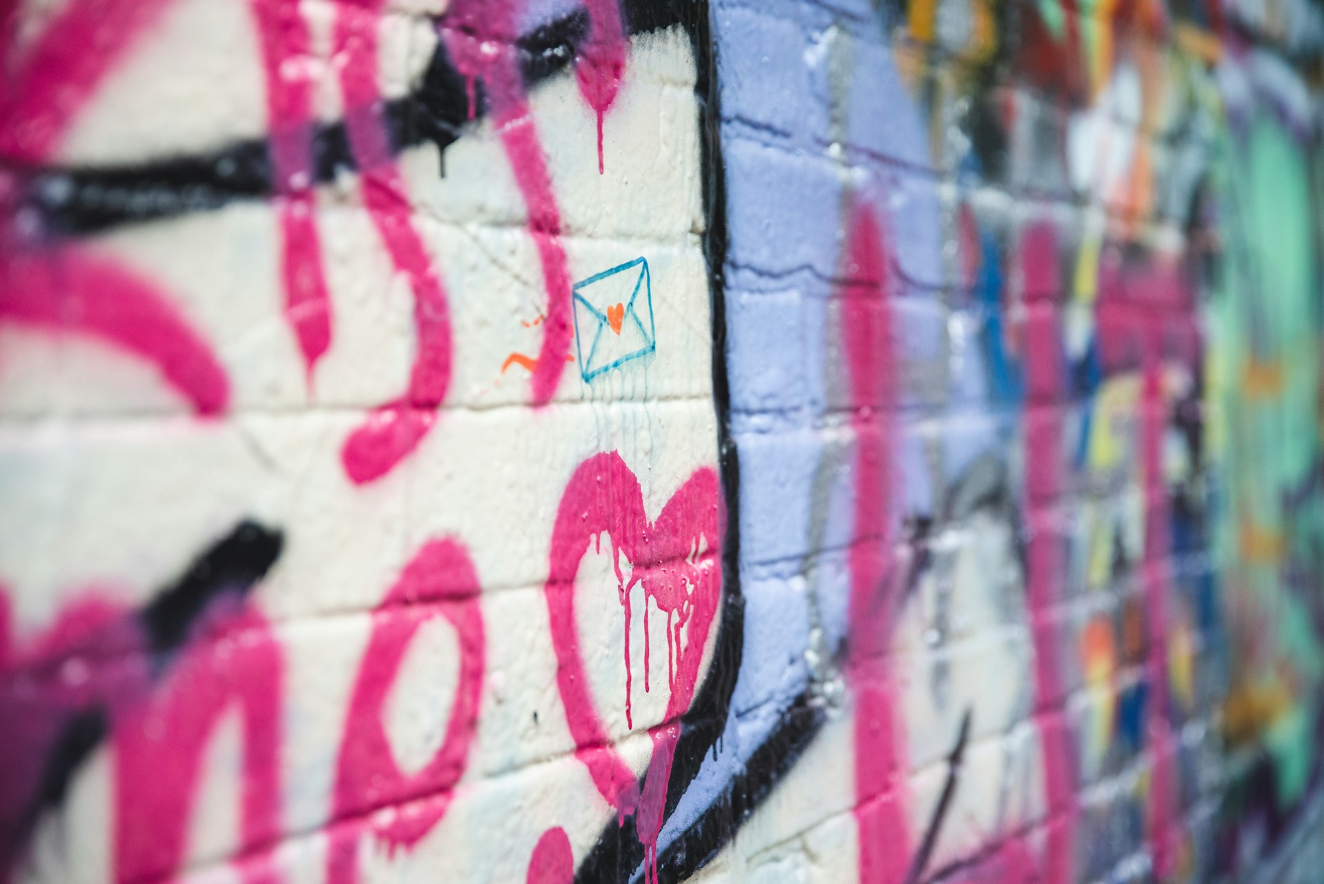 a wall covered in lots of colorful graffiti