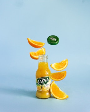 a bottle of jaffa orange juice falling into the air