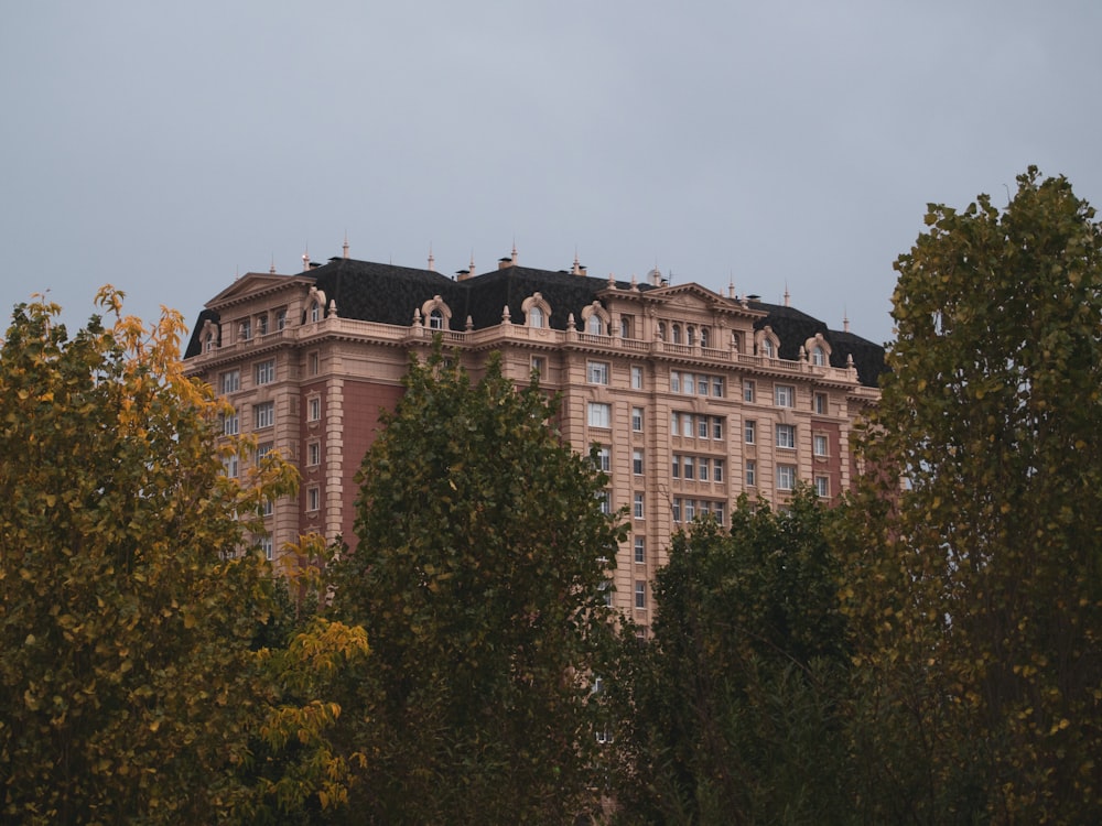 a large building surrounded by trees on a cloudy day