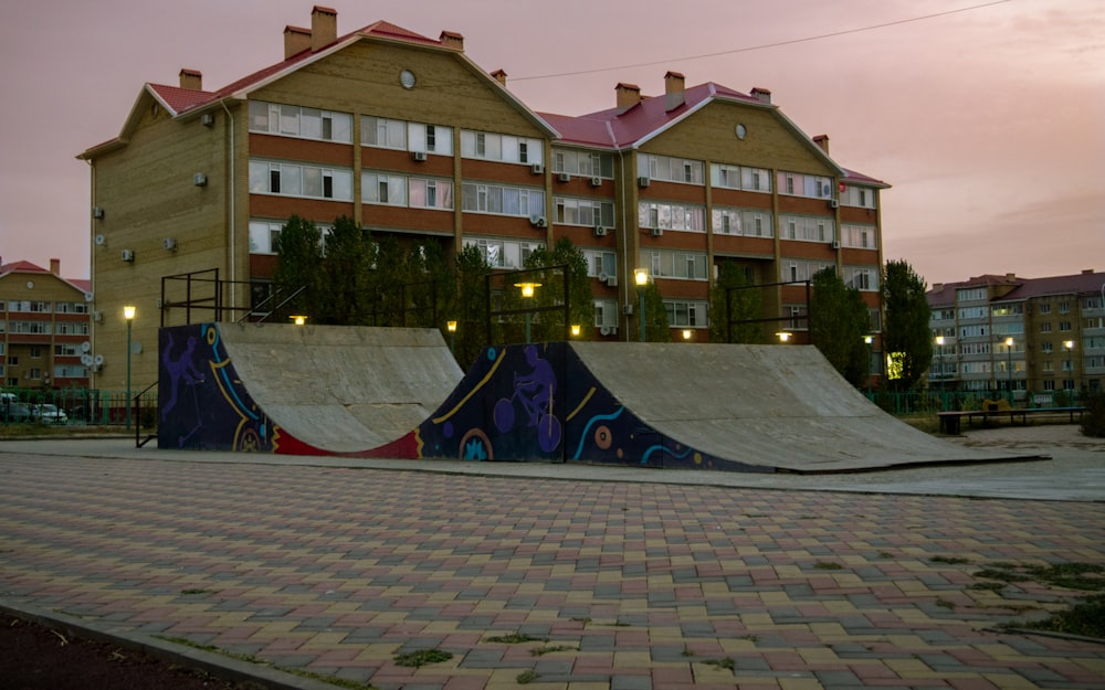 a skateboard park with a building in the background