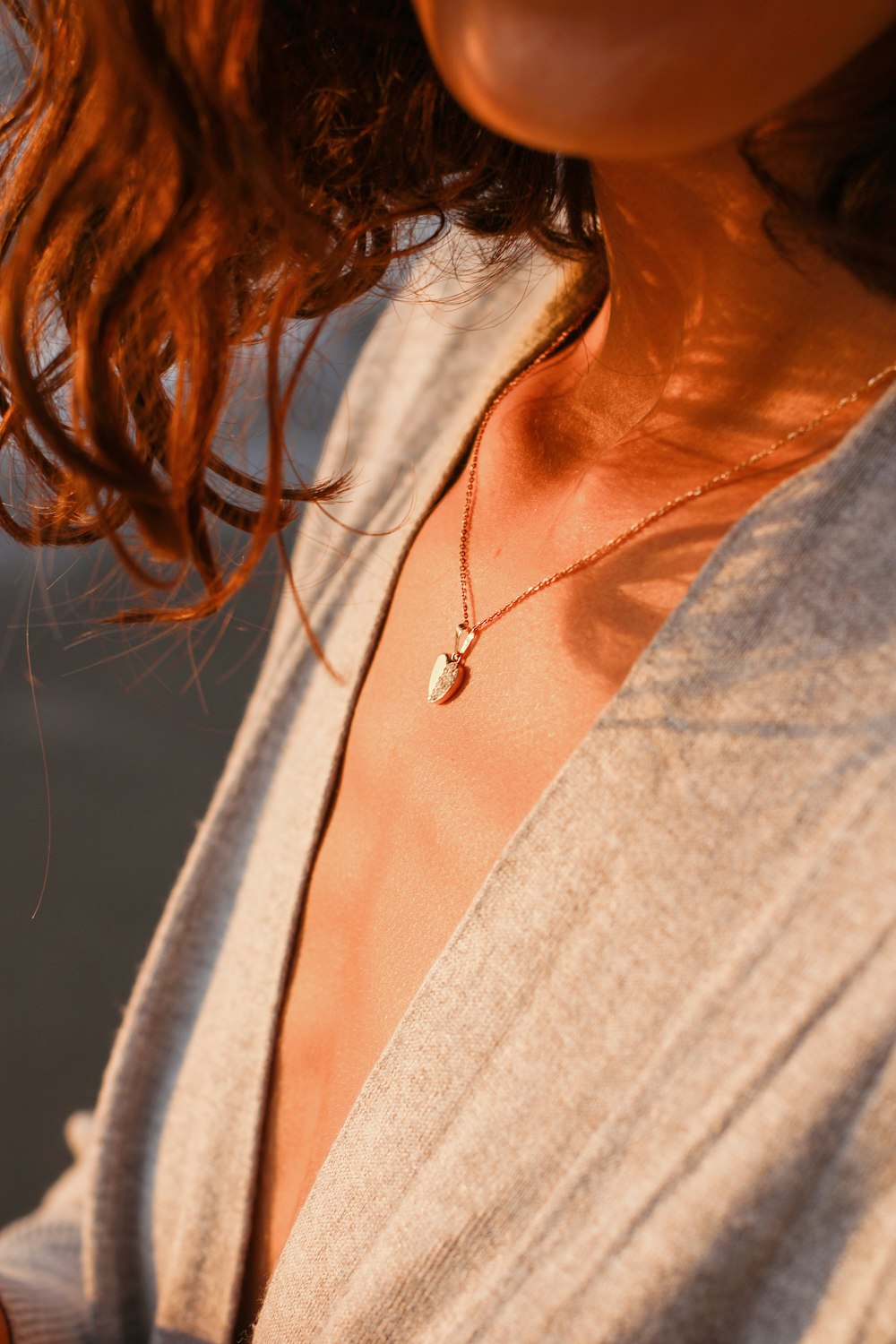 a close up of a person wearing a necklace