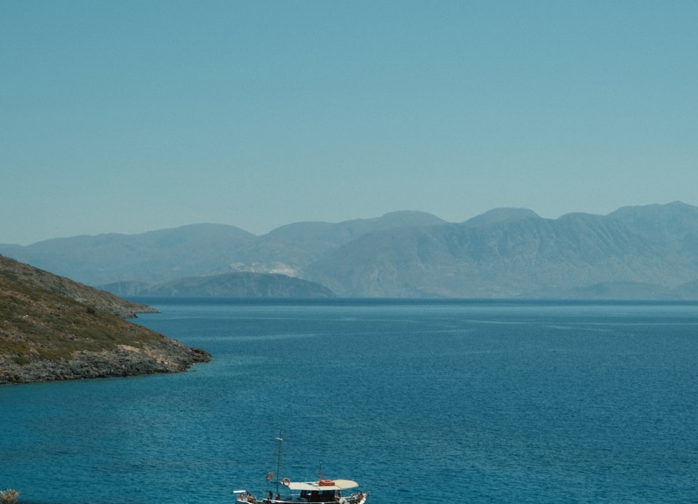 a boat floating on top of a large body of water