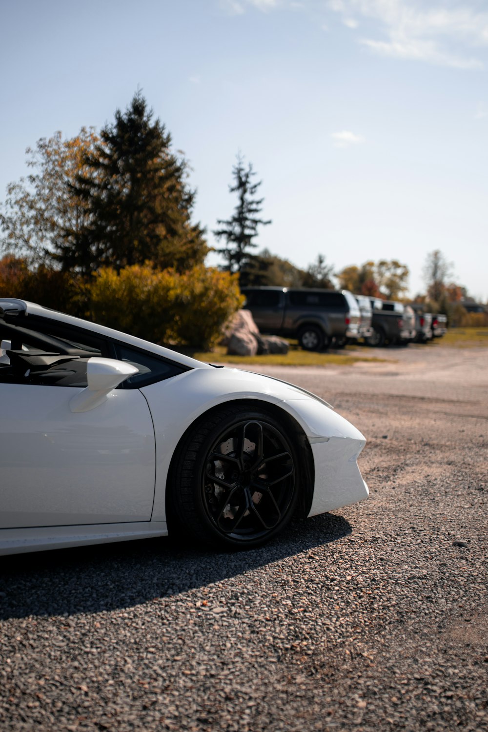 a white sports car parked in a parking lot