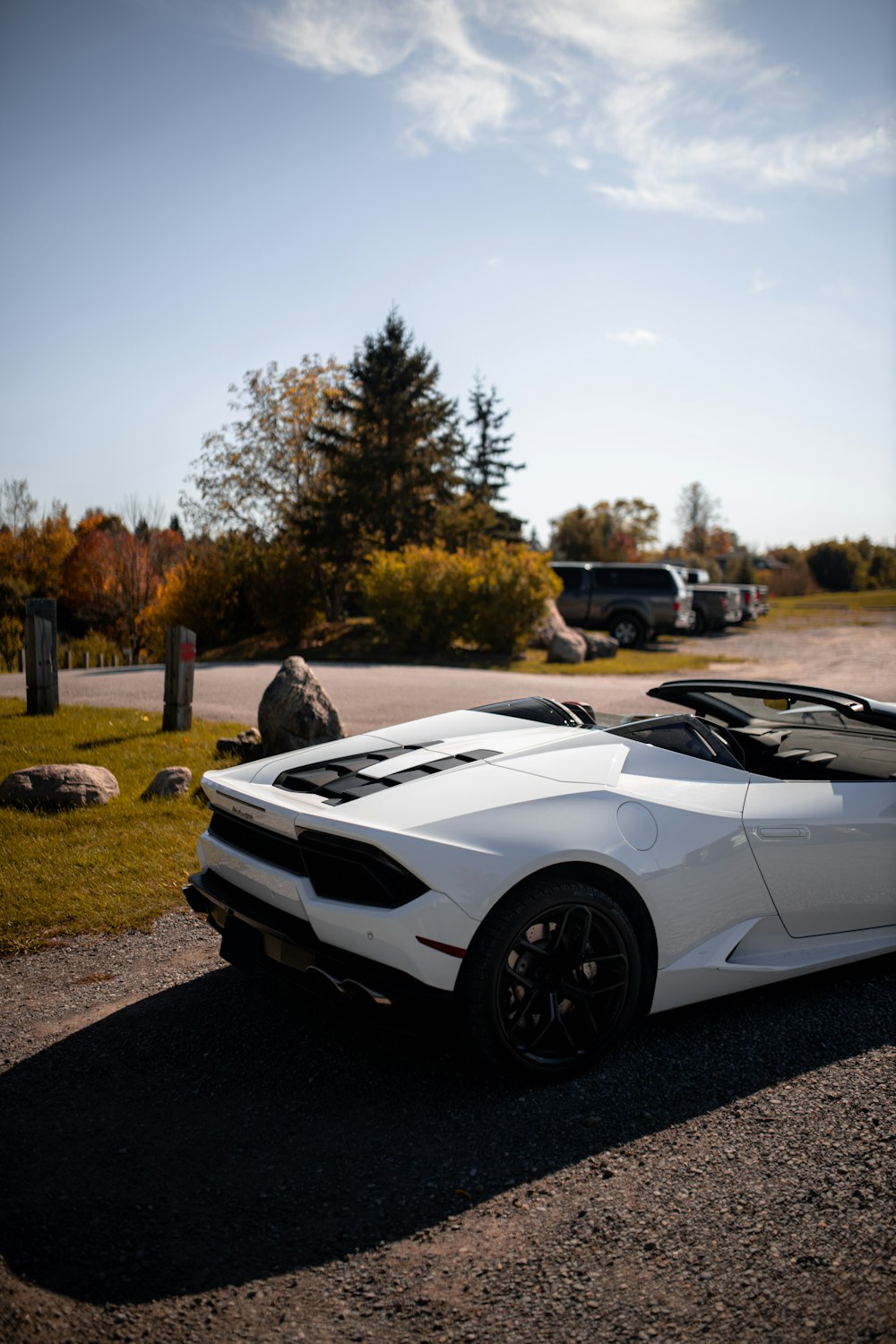 a white sports car parked in a parking lot