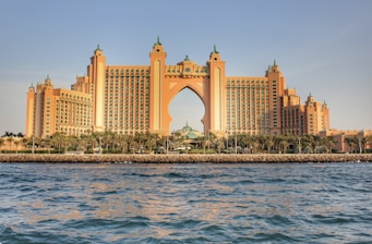 a very tall building sitting on top of a body of water