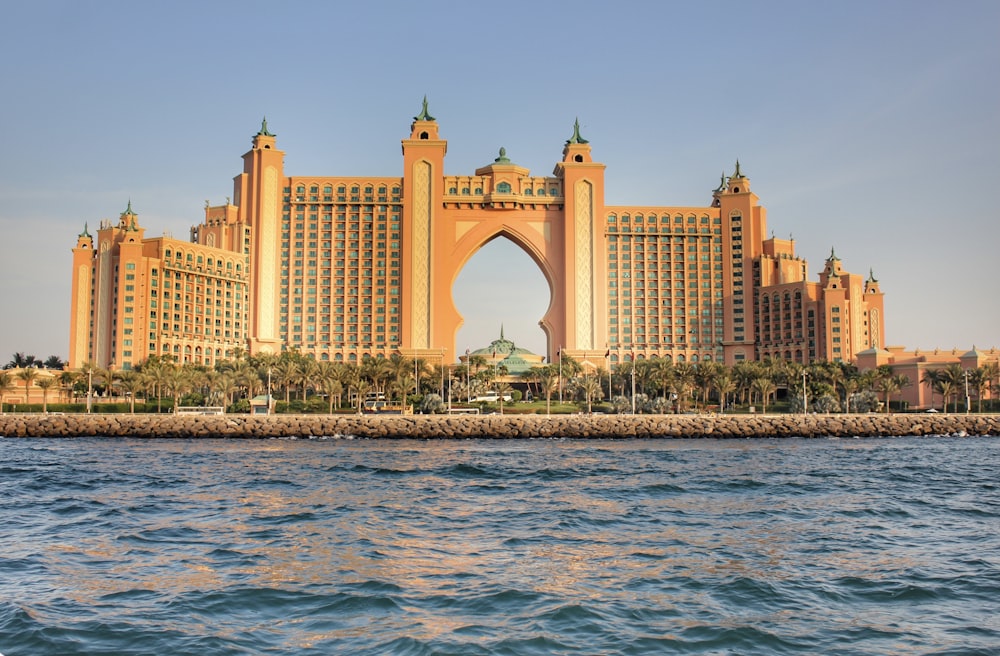 a very tall building sitting on top of a body of water