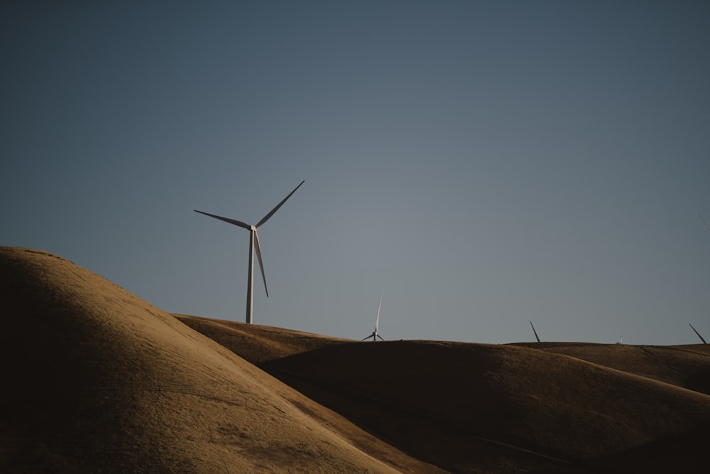 a wind turbine on top of a hill