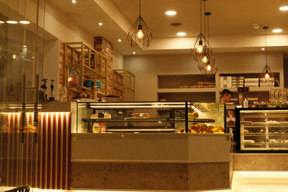 a man is behind a counter in a bakery