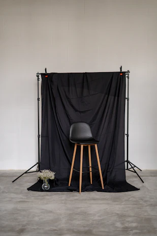 Therapist demonstrating posture correction techniques using a minimalist design backdrop