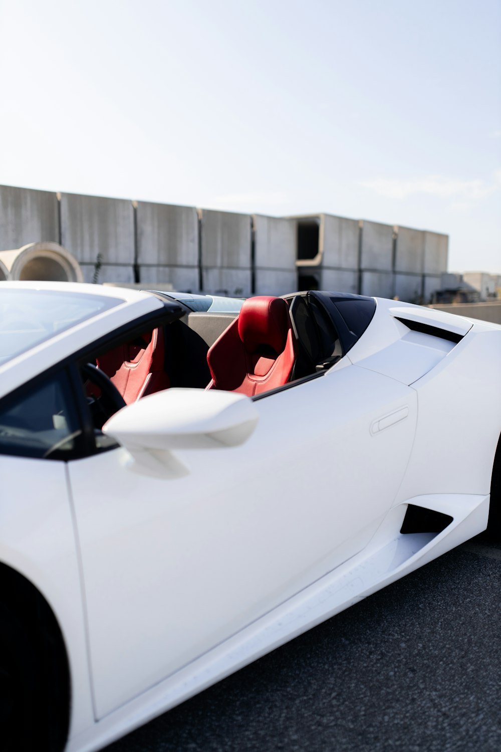 a white sports car parked on the side of the road