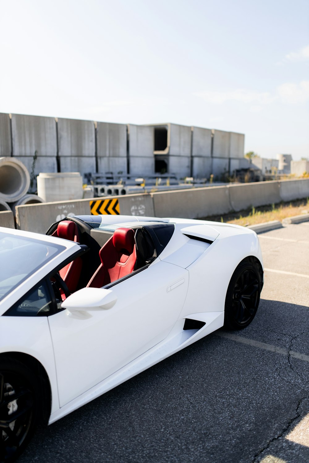 a white sports car parked on the side of the road