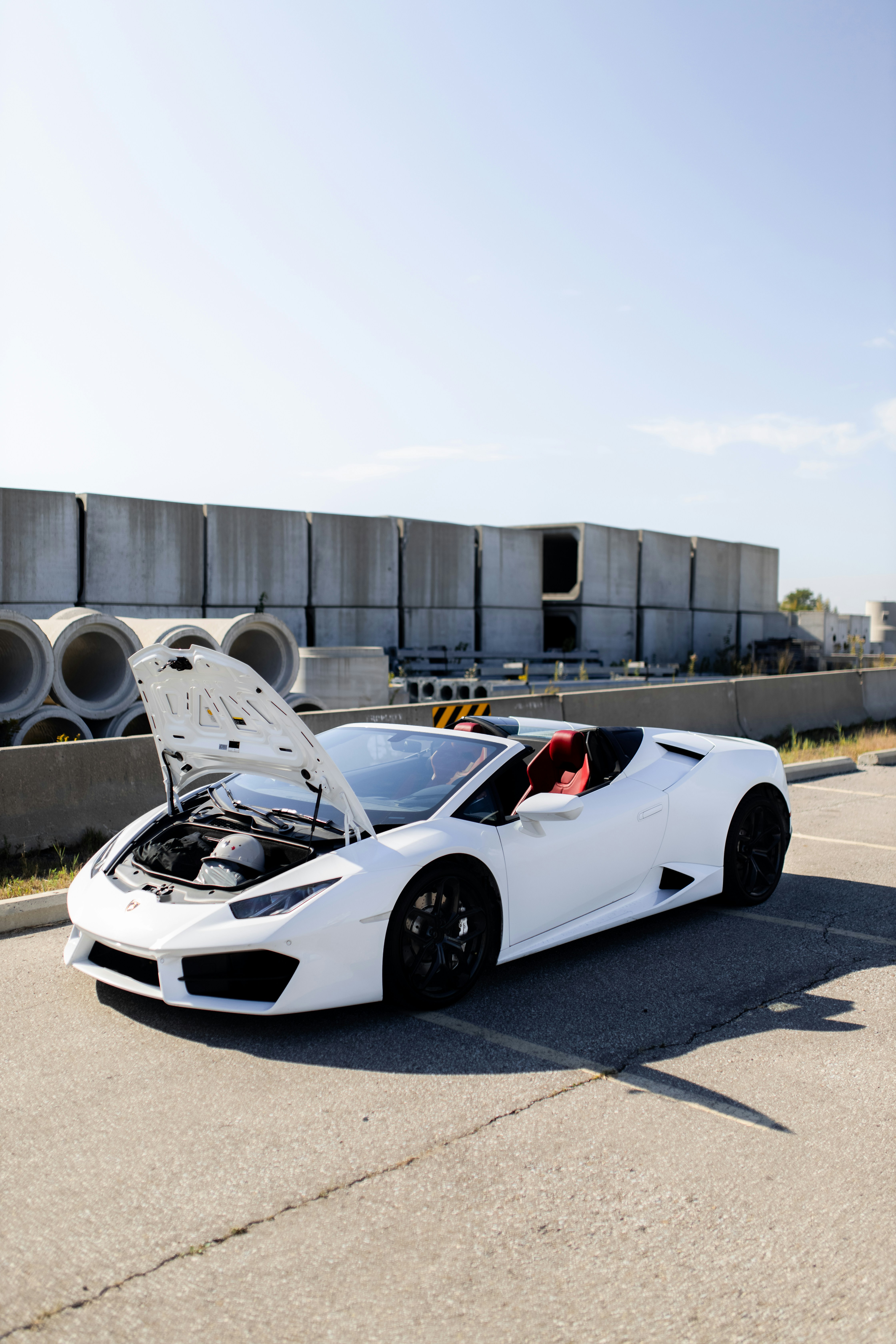 a white sports car with its hood open