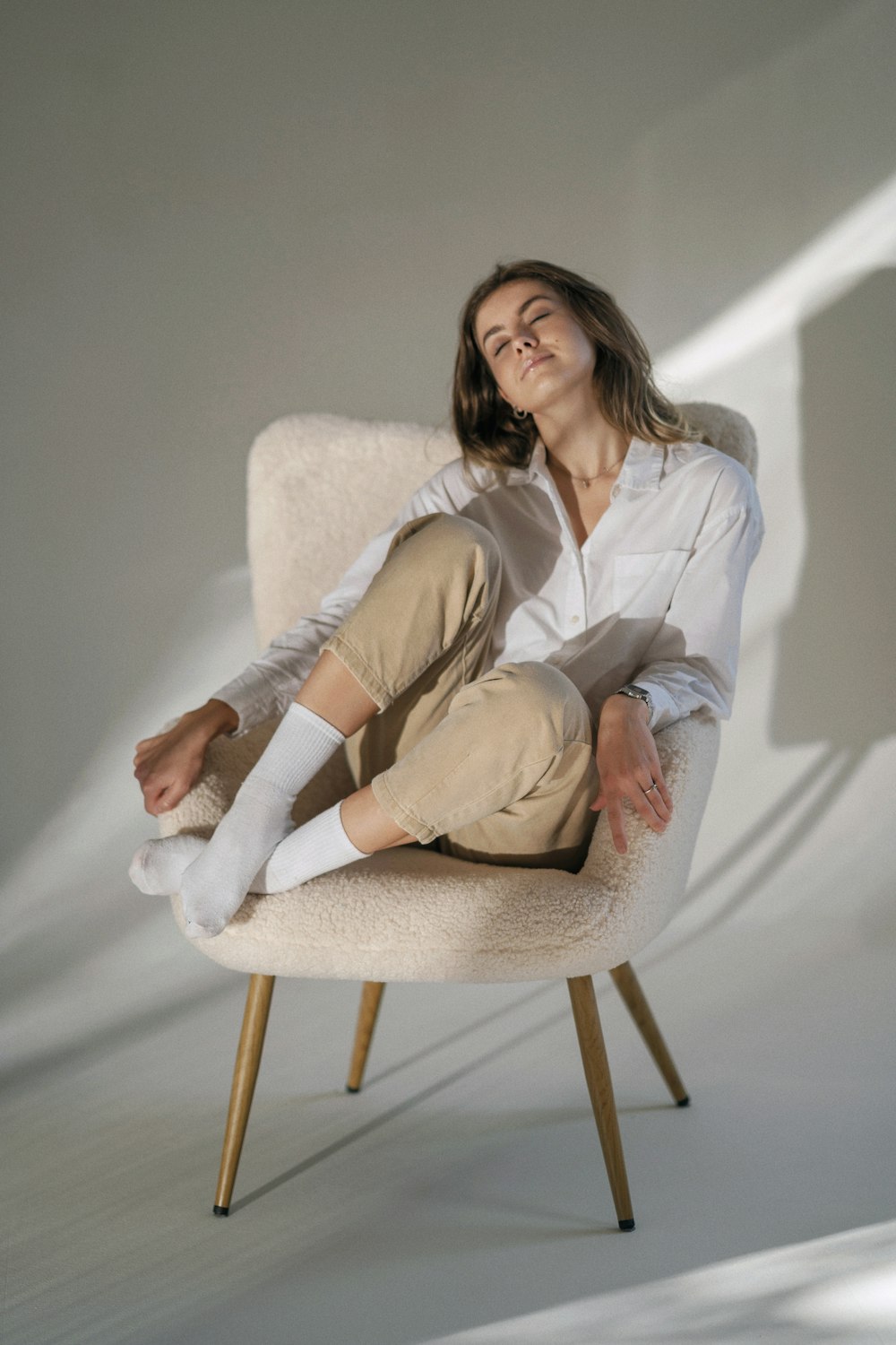 a woman sitting on a chair with her legs crossed