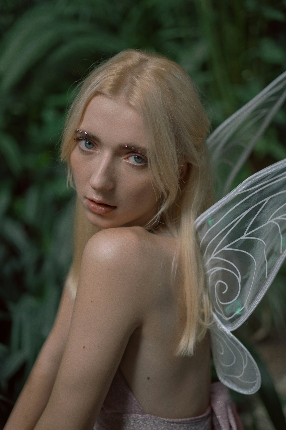 a woman in a fairy costume poses for a photo